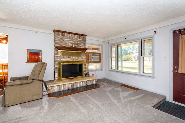 living room with a fireplace, carpet, and a textured ceiling