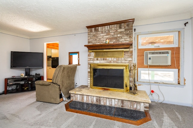 living room featuring carpet flooring, a textured ceiling, a wall mounted AC, and a fireplace