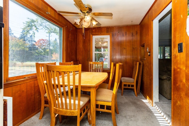 21048 Whitlock St, Farmington Hills, MI 48336 - carpeted dining room featuring plenty of natural light, wood walls, and a ceiling fan