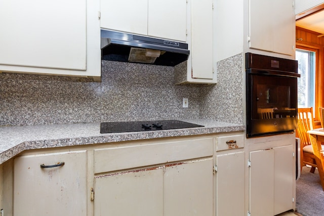 21048 Whitlock St, Farmington Hills, MI 48336 - kitchen featuring under cabinet range hood, black appliances, white cabinets, decorative backsplash, and light countertops