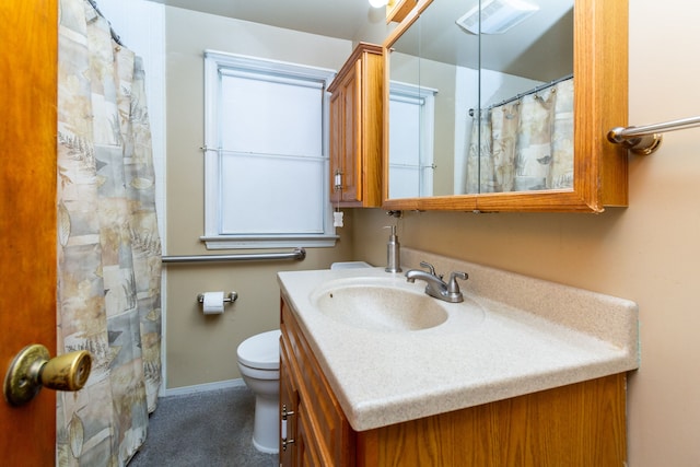 bathroom featuring vanity and toilet