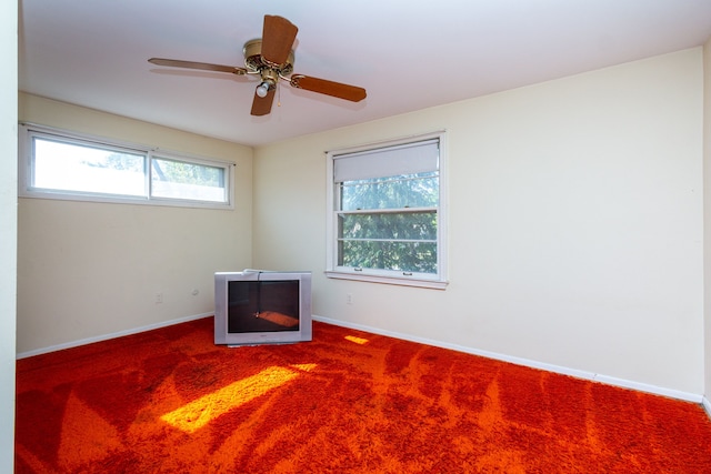 spare room with carpet, ceiling fan, and a wealth of natural light