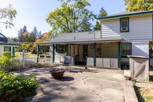 rear view of house featuring a patio and a fire pit