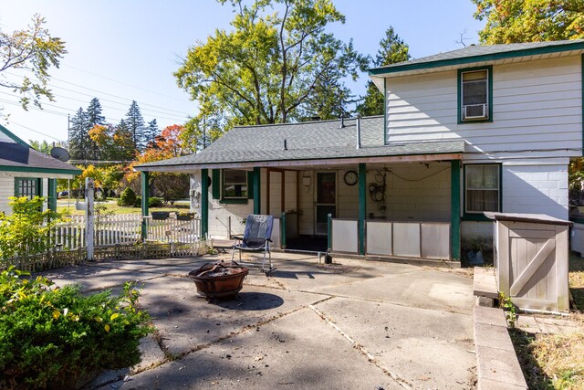 21048 Whitlock St, Farmington Hills, MI 48336 - back of property featuring a fire pit, a patio area, and a shingled roof