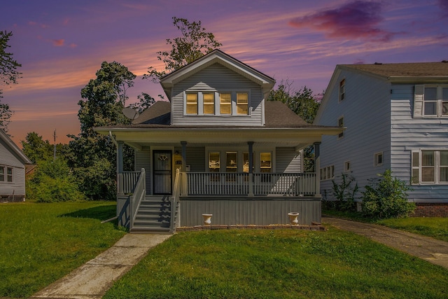 view of front of property featuring a porch and a yard