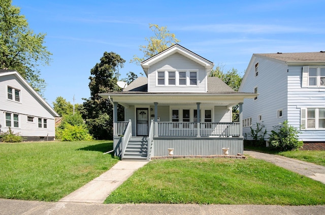 bungalow-style house featuring covered porch and a front yard