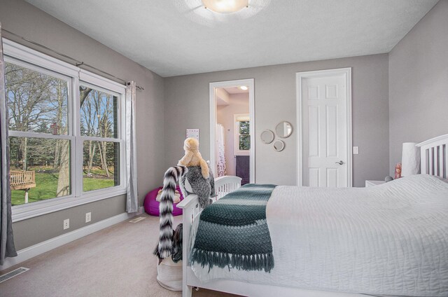 bedroom with carpet and a textured ceiling