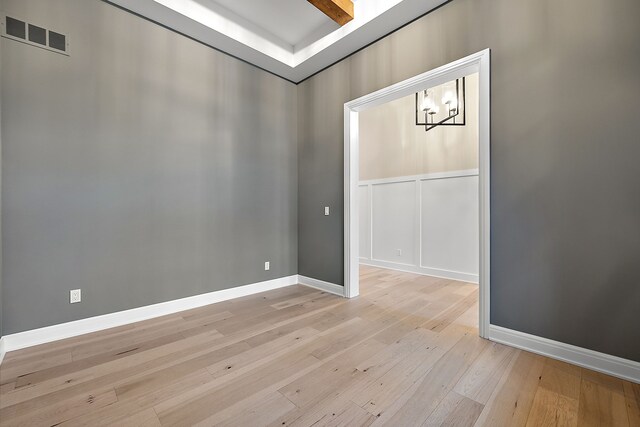2280 Heidi Dr, Oxford, MI 48370 - spare room featuring light wood finished floors, a chandelier, and baseboards