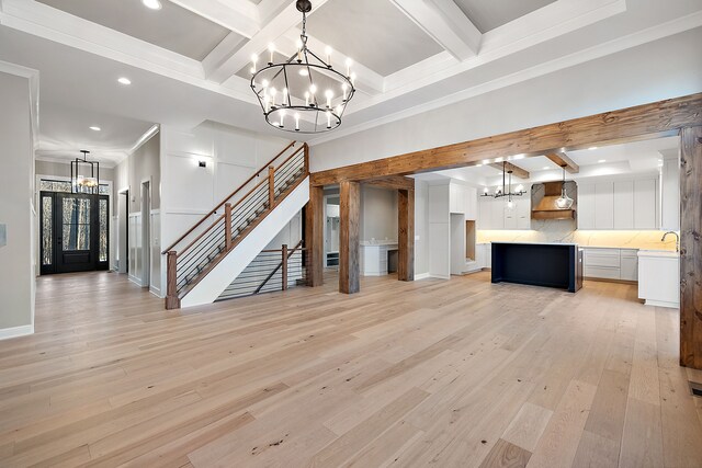 2280 Heidi Dr, Oxford, MI 48370 - unfurnished living room featuring a chandelier, beam ceiling, recessed lighting, coffered ceiling, and light wood finished floors