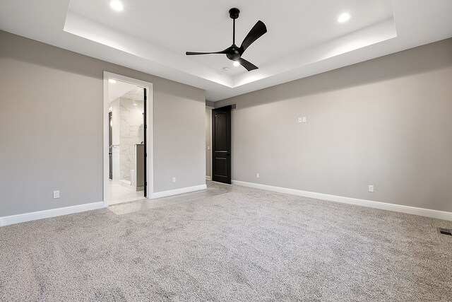 2280 Heidi Dr, Oxford, MI 48370 - unfurnished bedroom featuring a tray ceiling, light carpet, recessed lighting, baseboards, and a ceiling fan