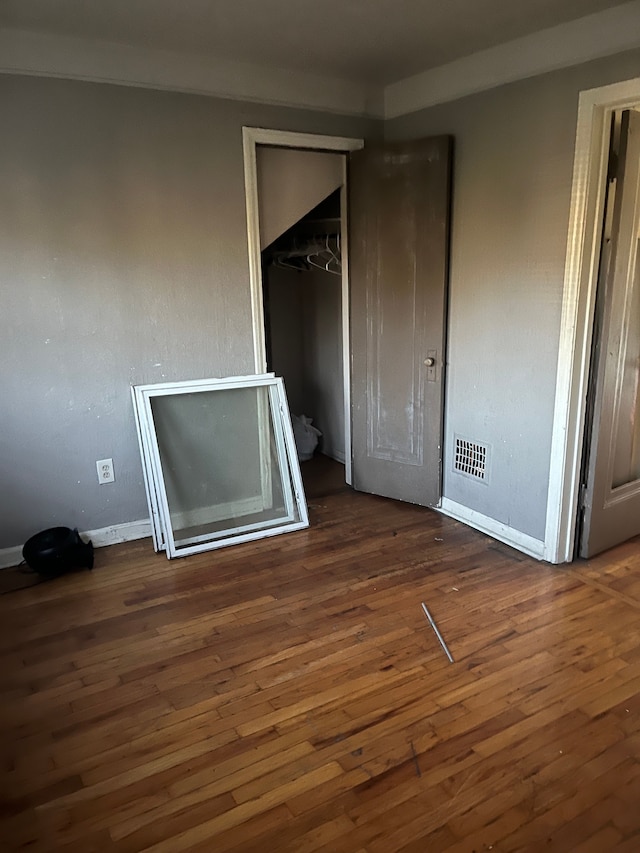 unfurnished bedroom featuring dark hardwood / wood-style flooring