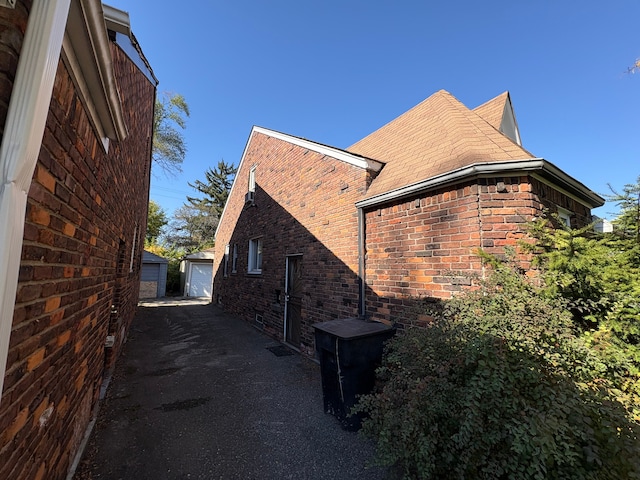 view of property exterior featuring a garage and an outbuilding