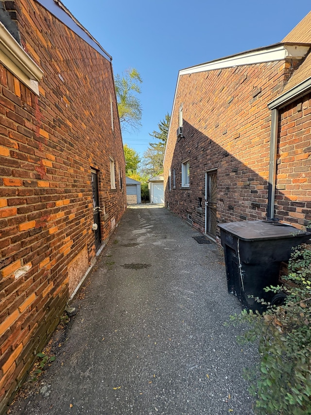 view of side of home with a garage and an outbuilding