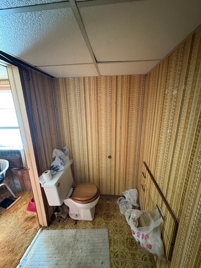 bathroom featuring a paneled ceiling and toilet