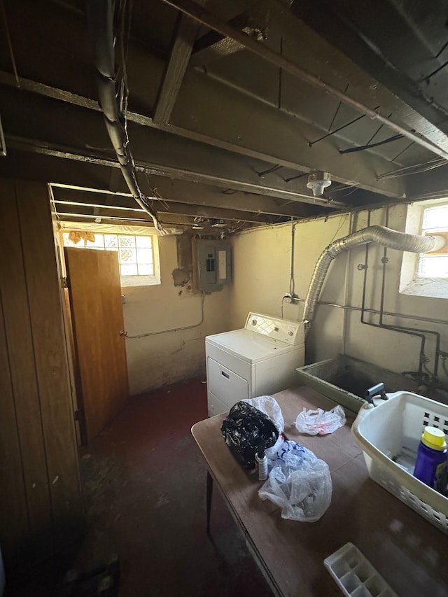 basement featuring electric panel and washer and clothes dryer