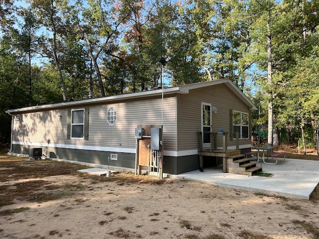 rear view of house featuring central AC and a patio