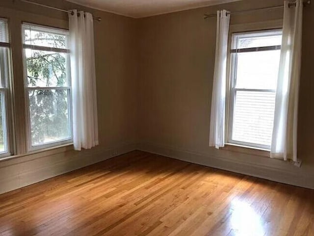 spare room featuring light hardwood / wood-style flooring