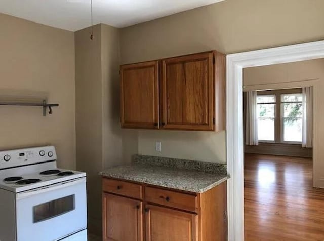 kitchen featuring light wood-type flooring and white electric range