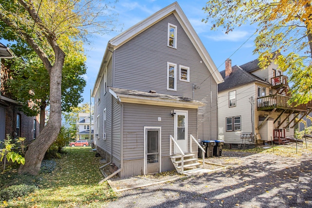 back of house with a deck