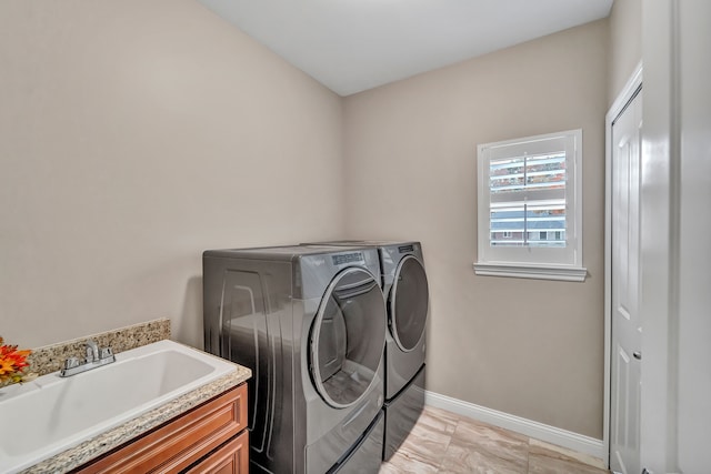 laundry area with cabinets, sink, and washer and dryer