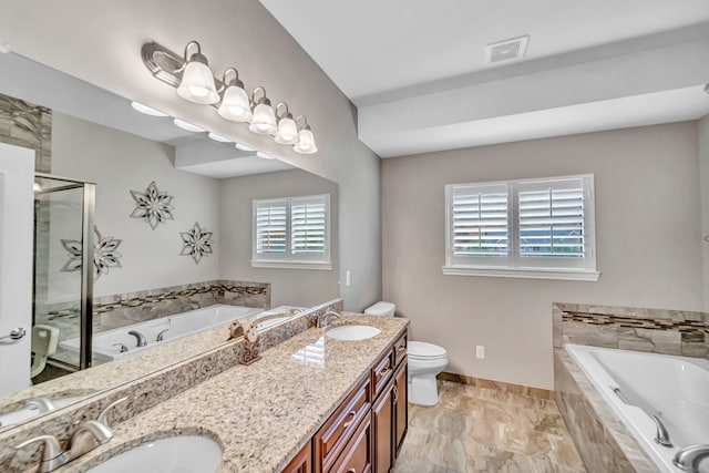 full bathroom featuring vanity, toilet, and independent shower and bath