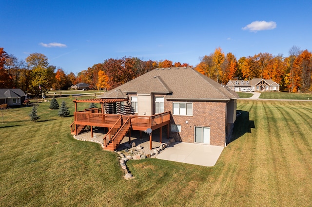 back of house featuring a wooden deck, a patio area, and a yard