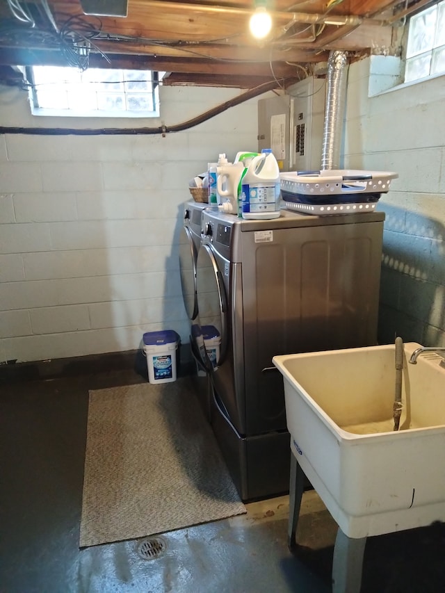 laundry room with separate washer and dryer, sink, and a wealth of natural light