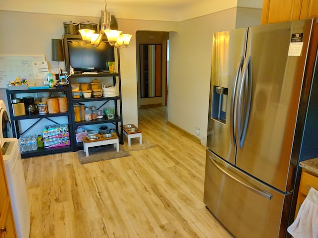 kitchen featuring decorative light fixtures, light wood-type flooring, stainless steel refrigerator with ice dispenser, and an inviting chandelier