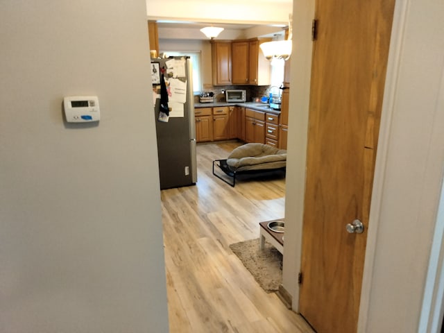 corridor featuring light hardwood / wood-style floors and sink