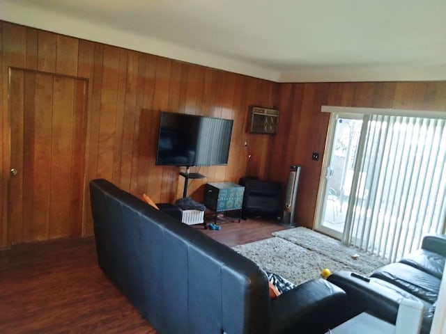 living room featuring wooden walls and dark wood-type flooring