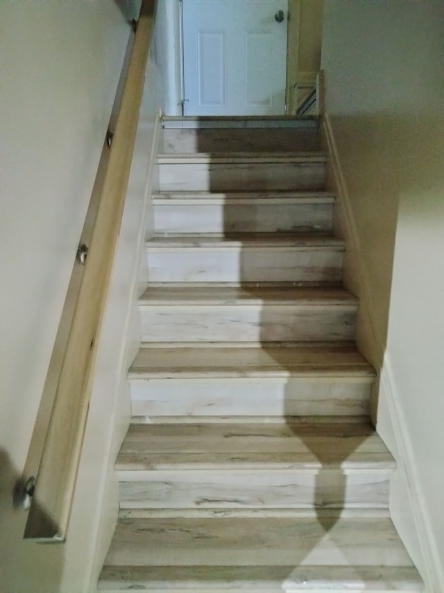 stairs with hardwood / wood-style flooring