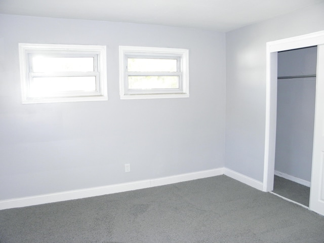 unfurnished bedroom with dark colored carpet