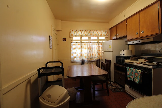 kitchen featuring backsplash and white range oven