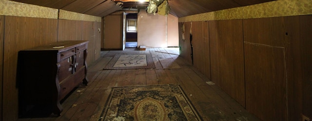 bonus room featuring wood ceiling, wooden walls, dark wood-type flooring, and vaulted ceiling