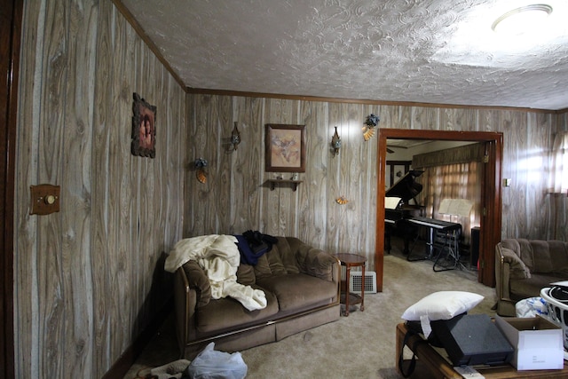 living room featuring wooden walls, crown molding, a textured ceiling, and light carpet