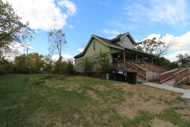 view of home's exterior featuring a lawn and covered porch