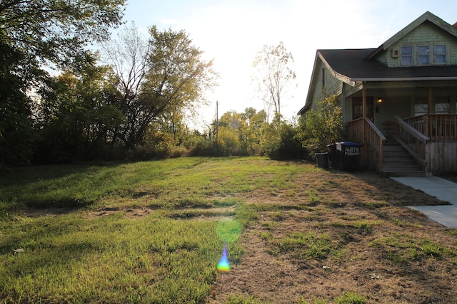 view of yard featuring covered porch