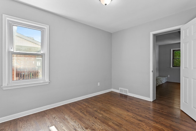 empty room with dark hardwood / wood-style floors