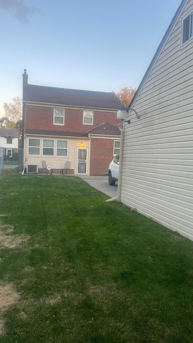 rear view of house with a lawn