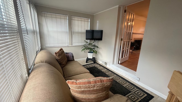 living room featuring light hardwood / wood-style floors and ornamental molding