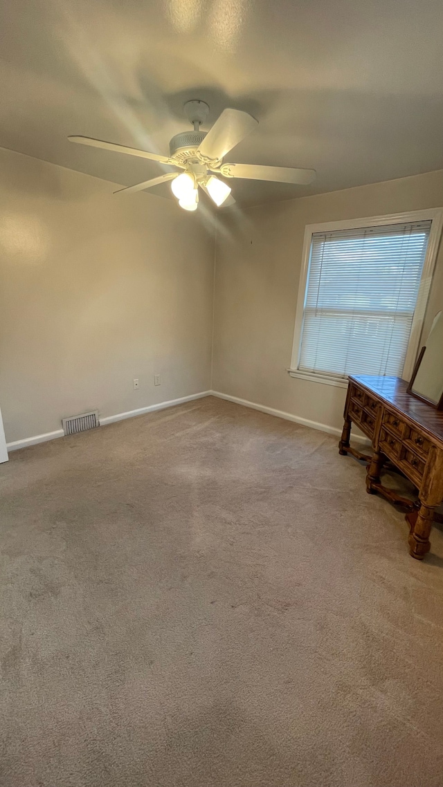 carpeted empty room with ceiling fan