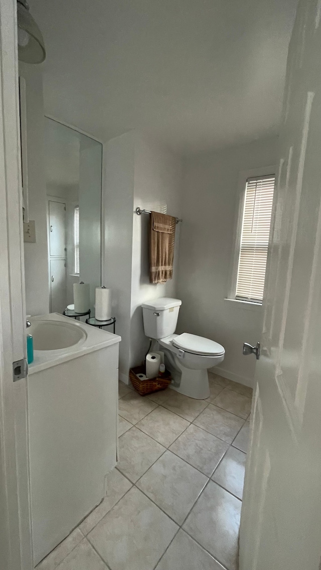 bathroom featuring tile patterned floors, vanity, and toilet