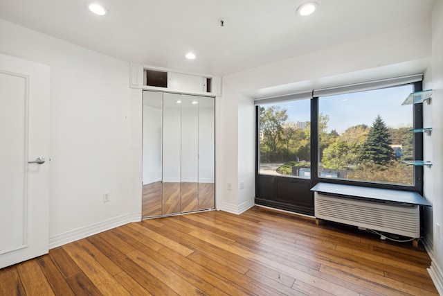 unfurnished bedroom with hardwood / wood-style flooring