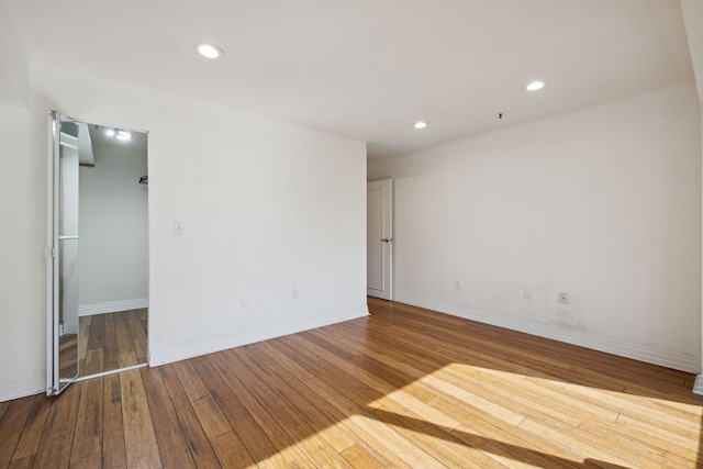 1001 W Jefferson Ave Unit 2E, Detroit, MI 48226 - spare room featuring hardwood / wood-style flooring, recessed lighting, and baseboards