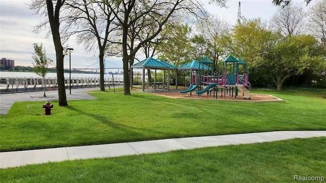 view of playground featuring a water view and a yard