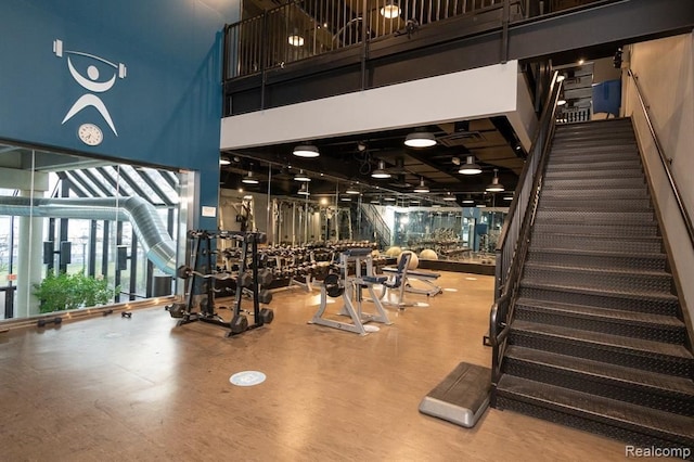 workout area with a towering ceiling