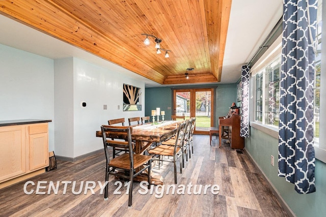 dining space featuring french doors, dark hardwood / wood-style flooring, a tray ceiling, and wood ceiling