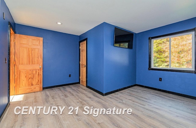 unfurnished room with wood-type flooring