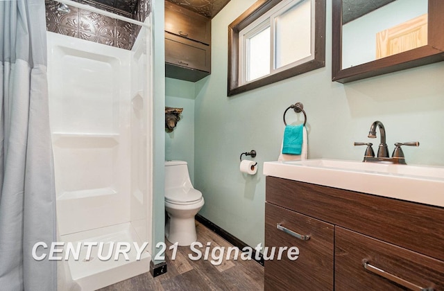 bathroom featuring vanity, curtained shower, toilet, and wood-type flooring