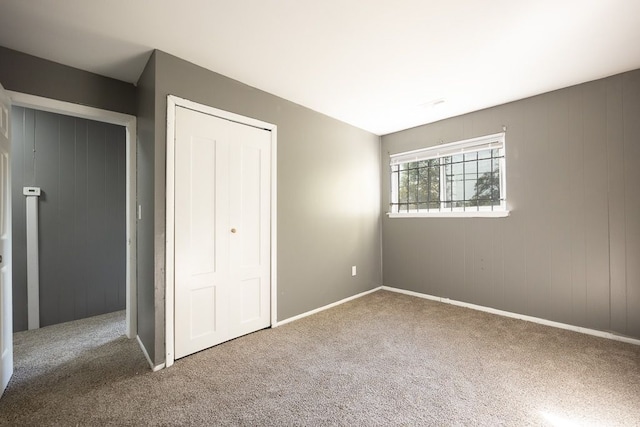 unfurnished bedroom with a closet and carpet floors